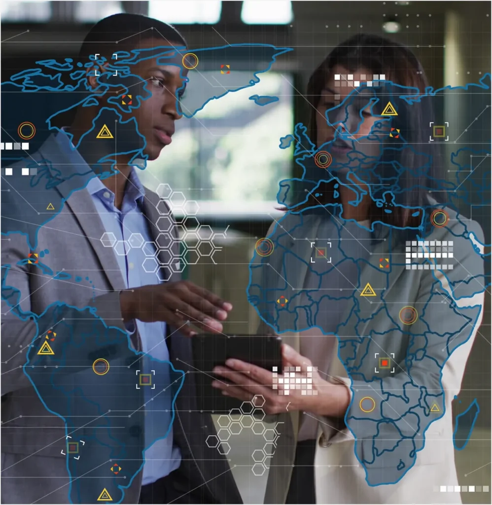Two executives reviewing a tablet over a world map graphic, illustrating a CSO's view across every location
