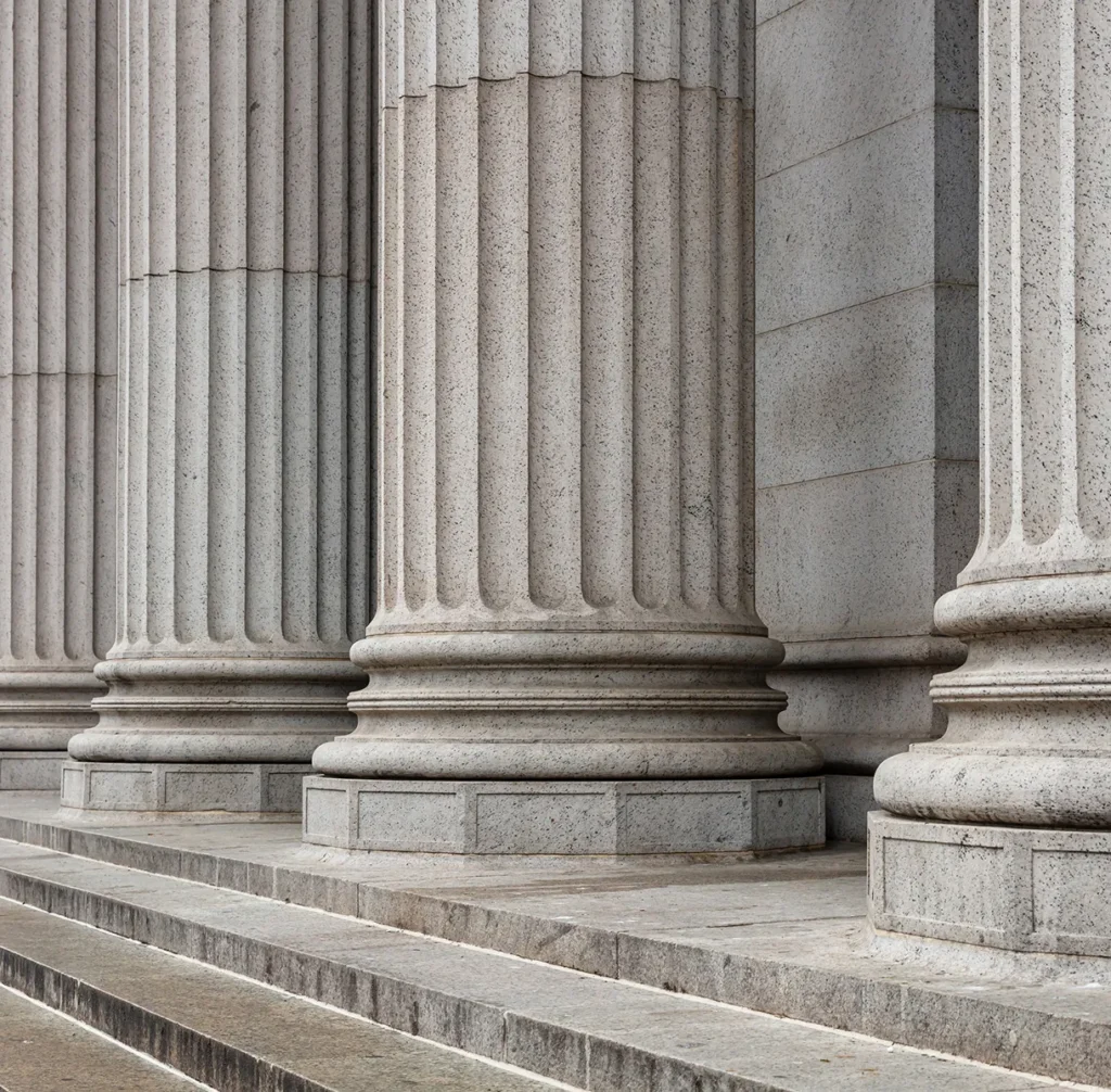Stone columns on the steps of a government building, illustrating standards-aligned risk assessment for the public sector