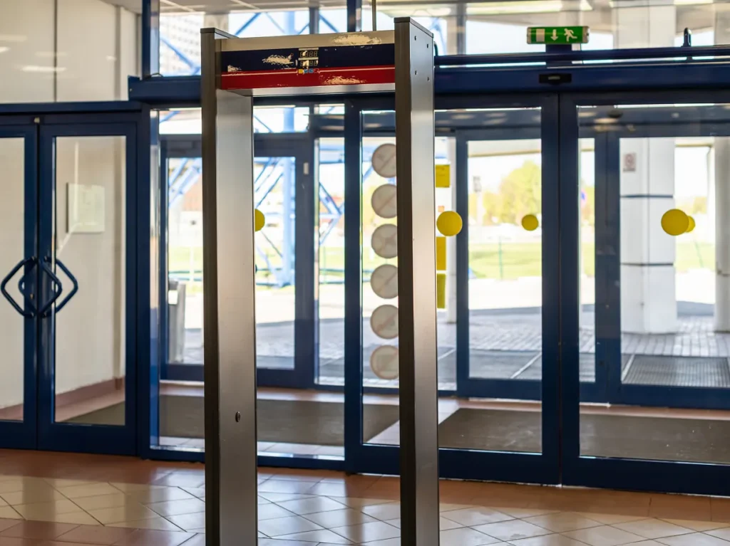 Walk-through metal detector at a public building entrance, illustrating open-access security obligations in government