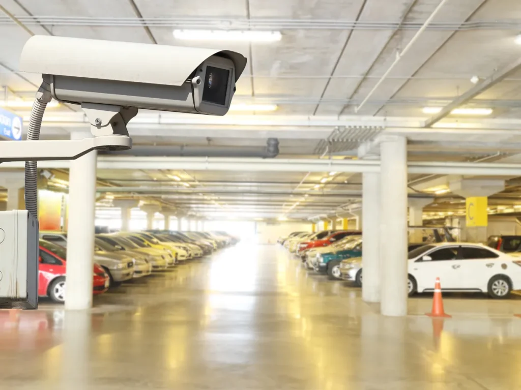 Security camera in a parking garage, illustrating criminal threat exposure at a location