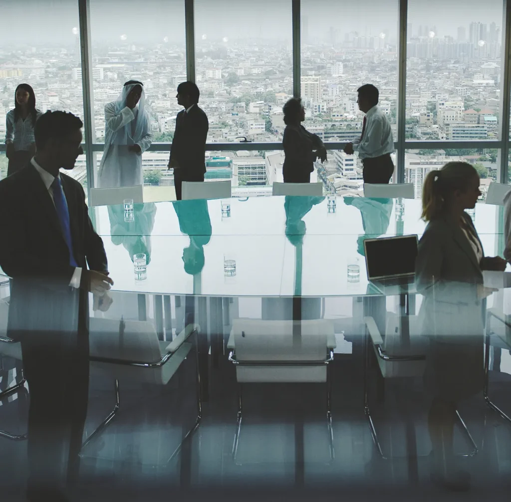 Silhouetted executives around a glass boardroom table with a city view, illustrating executive leadership knowing where the organization stands