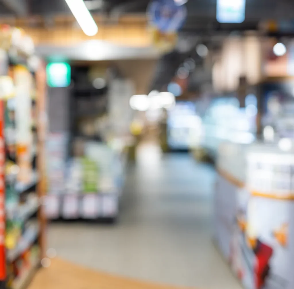 Blurred retail store aisle with shelves of products, illustrating loss risk and physical security in retail