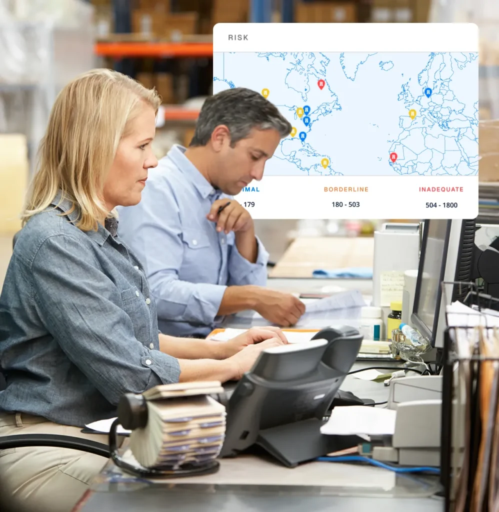 Two risk analysts at a desk with a Circadian Risk world map overlay, for facilities and operations teams