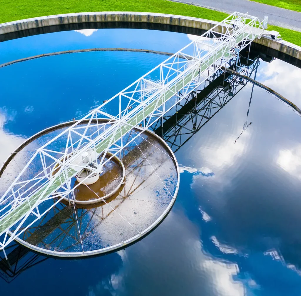 Aerial view of a circular water treatment tank, illustrating critical infrastructure protection for water and utilities